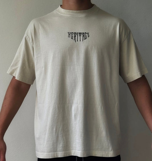 Heritage Tee — espalda con figura Taína ilustrada y Pride Spirit en script